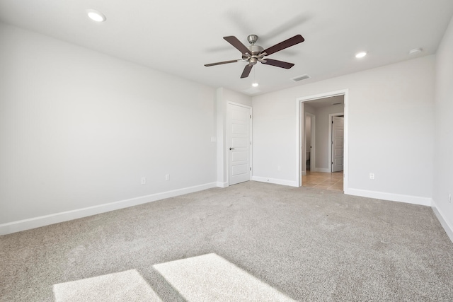 unfurnished bedroom featuring light carpet and ceiling fan