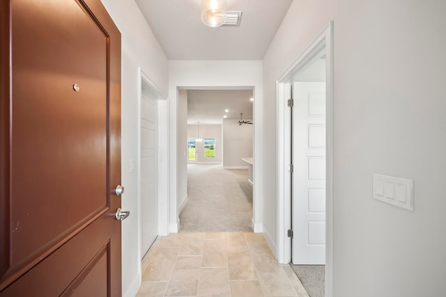 hallway featuring light carpet