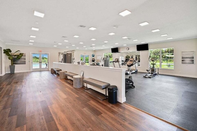 gym with dark hardwood / wood-style floors and french doors