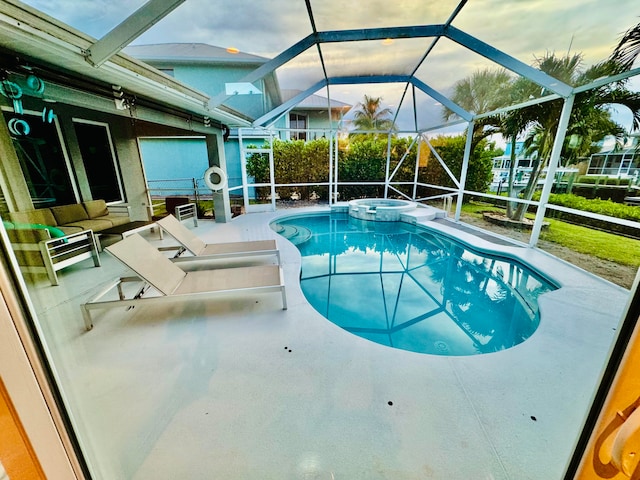 view of swimming pool featuring a lanai and a patio area