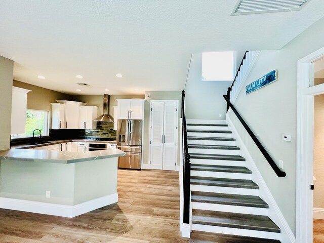 bathroom featuring a shower with shower door and hardwood / wood-style floors