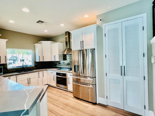 kitchen featuring sink, white cabinetry, and stainless steel appliances