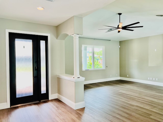 foyer with ceiling fan, light hardwood / wood-style flooring, and decorative columns