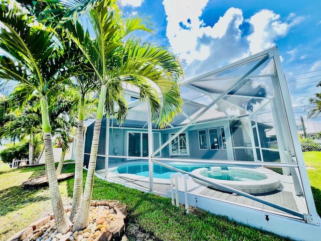 view of swimming pool featuring a lanai