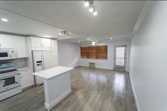 kitchen featuring light wood-type flooring, a center island, white cabinets, white appliances, and crown molding