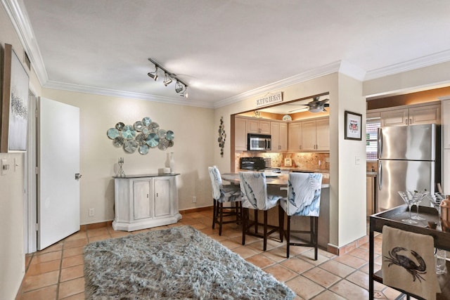 kitchen featuring ornamental molding, backsplash, light tile patterned floors, stainless steel appliances, and ceiling fan