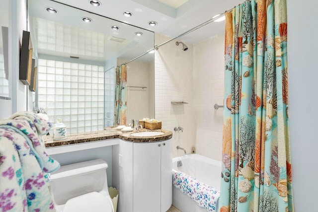 full bathroom with toilet, shower / bath combo with shower curtain, and vanity