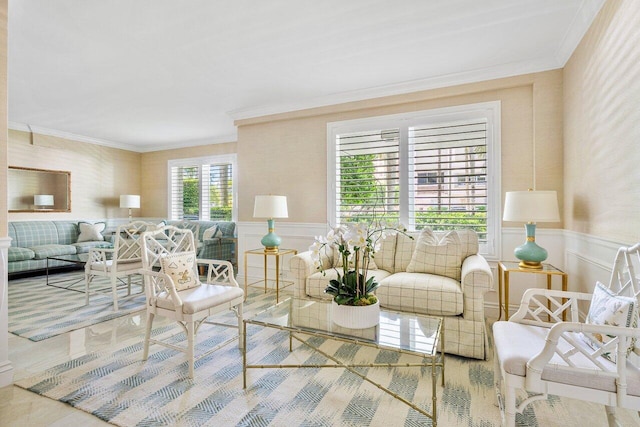 living room with ornamental molding, wainscoting, a decorative wall, and wallpapered walls