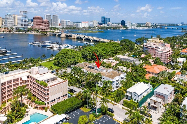 drone / aerial view featuring a view of city and a water view