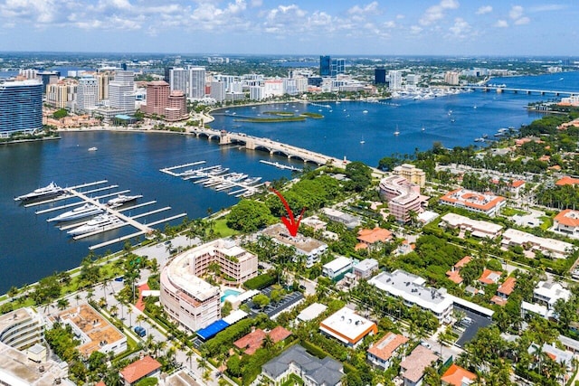 drone / aerial view featuring a view of city and a water view