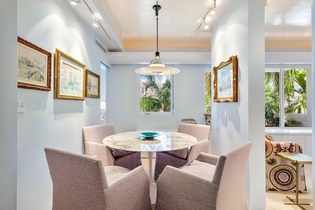 dining space featuring visible vents and track lighting