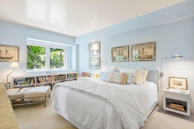 bedroom featuring light carpet