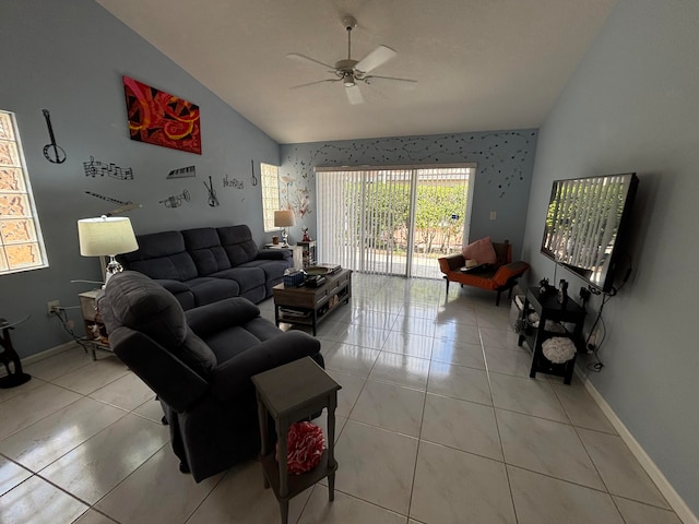 tiled living room featuring ceiling fan, a healthy amount of sunlight, and lofted ceiling