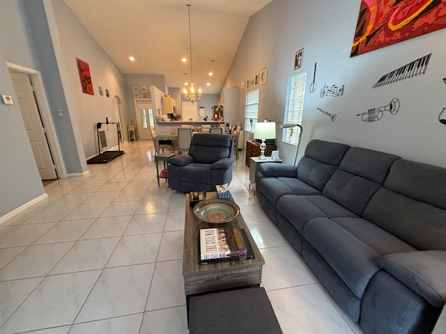 living room featuring a notable chandelier, high vaulted ceiling, and light tile patterned floors