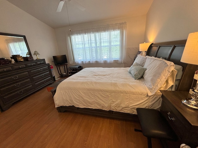 bedroom with lofted ceiling, hardwood / wood-style floors, and ceiling fan