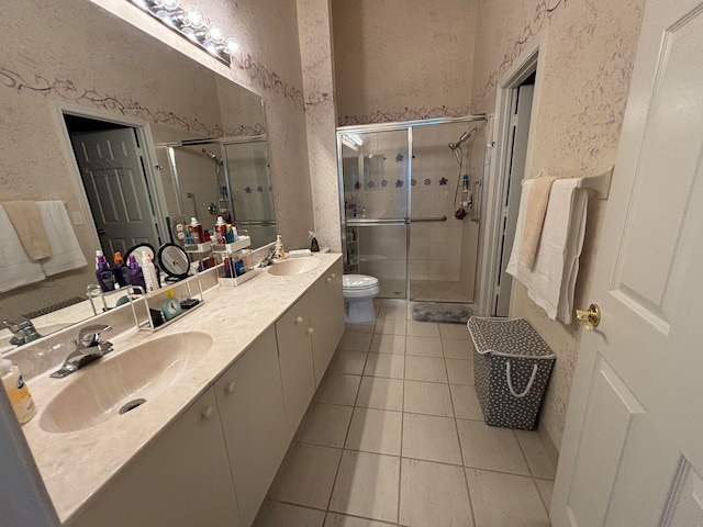 bathroom featuring vanity, tile patterned floors, toilet, and an enclosed shower