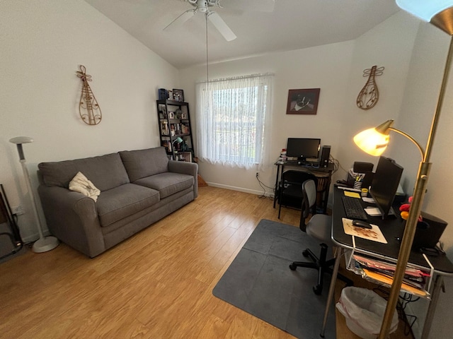 home office featuring hardwood / wood-style floors, ceiling fan, and vaulted ceiling