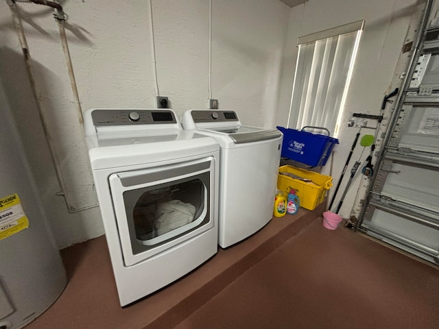 laundry area with water heater and separate washer and dryer