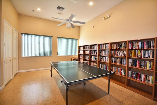 playroom featuring a towering ceiling and ceiling fan