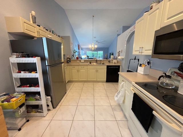 kitchen featuring stainless steel appliances, vaulted ceiling, light tile patterned flooring, and an inviting chandelier