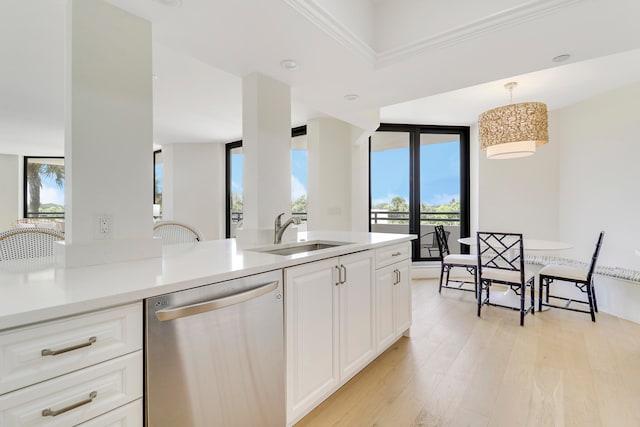 kitchen with light hardwood / wood-style flooring, floor to ceiling windows, dishwasher, sink, and white cabinets