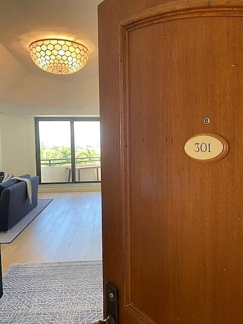 corridor featuring hardwood / wood-style flooring and wooden walls