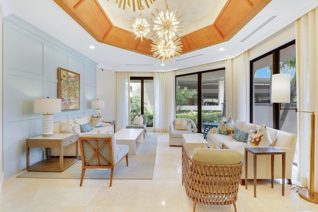 tiled living room with a tray ceiling and a chandelier