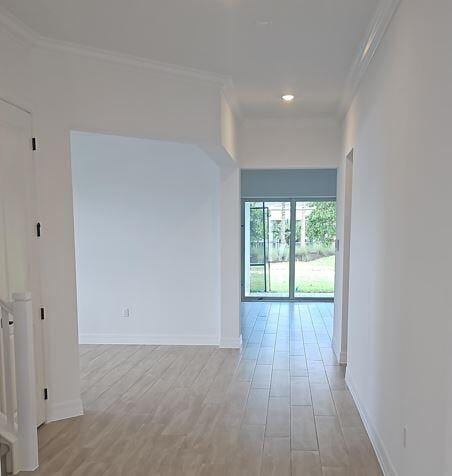 interior space with ornamental molding and light hardwood / wood-style flooring