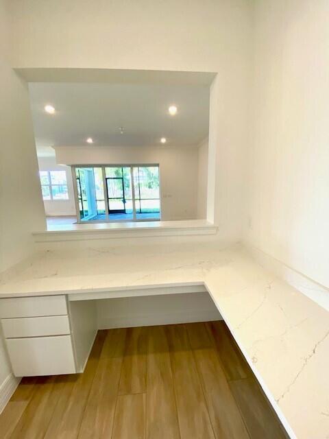 interior space featuring wood finished floors and recessed lighting