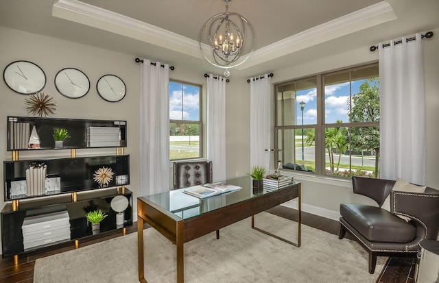 home office featuring ornamental molding, a tray ceiling, a notable chandelier, and wood finished floors