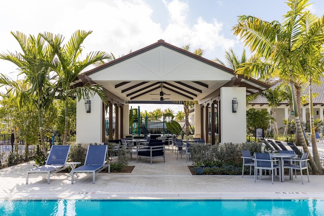 view of pool with ceiling fan, a gazebo, a patio, and fence