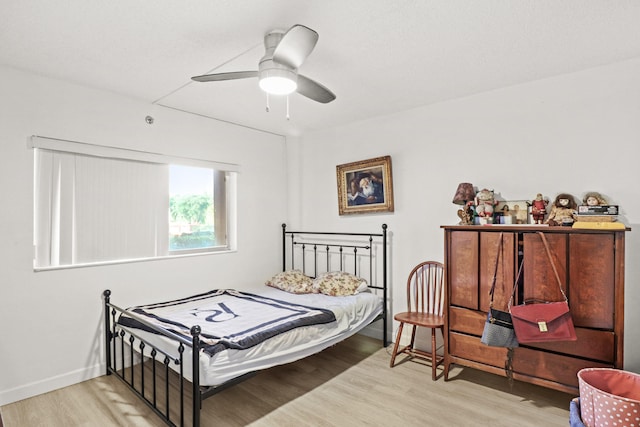 bedroom with ceiling fan and light wood-type flooring