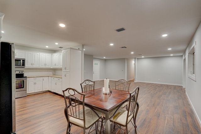 dining space featuring light hardwood / wood-style floors