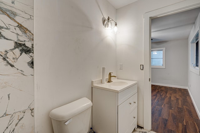 bathroom featuring hardwood / wood-style floors, vanity, and toilet