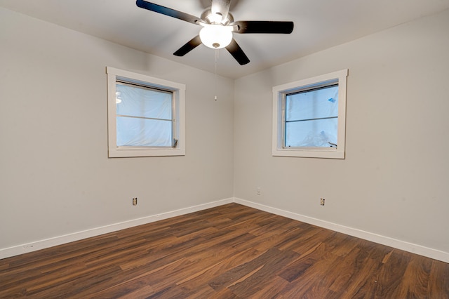 unfurnished room featuring dark wood-type flooring and ceiling fan