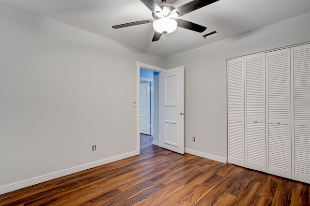 unfurnished bedroom with a closet, dark hardwood / wood-style floors, and ceiling fan