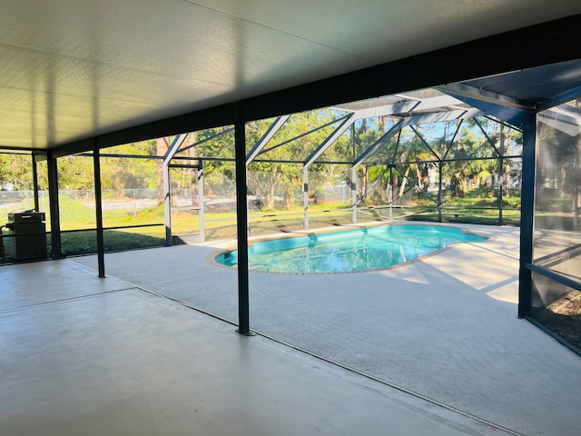 view of swimming pool with a lanai and a patio