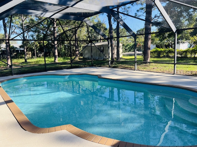 view of swimming pool with a yard and glass enclosure