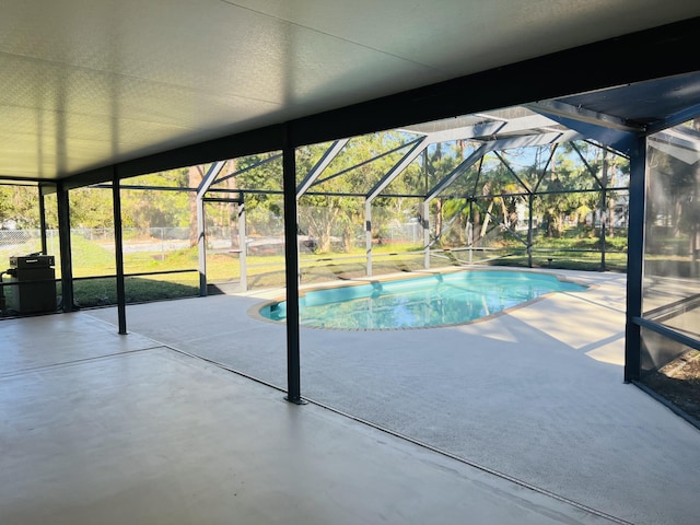 view of swimming pool with a patio and glass enclosure