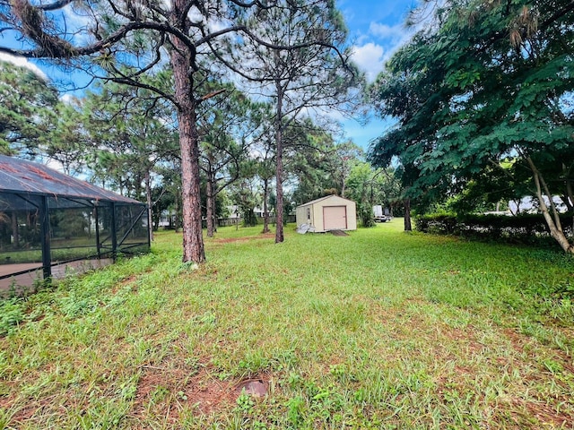 view of yard featuring a storage unit and glass enclosure