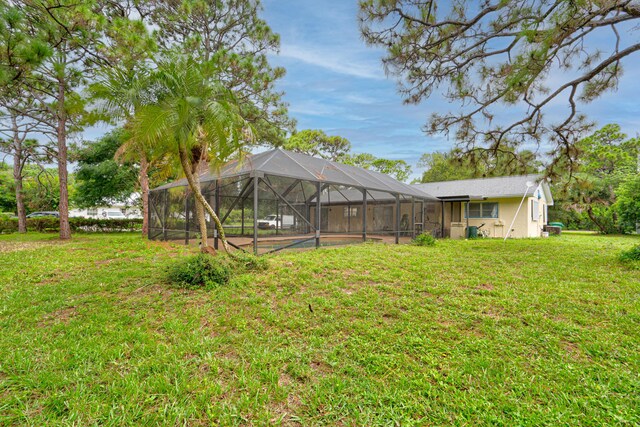 view of yard featuring glass enclosure and a swimming pool