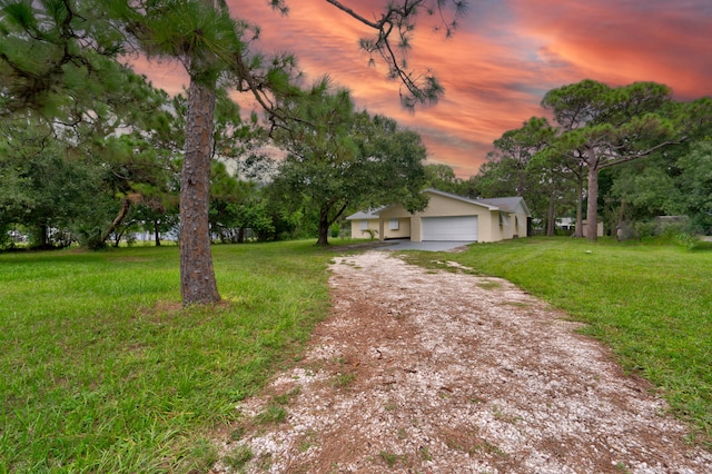 view of front of house featuring a lawn and a garage