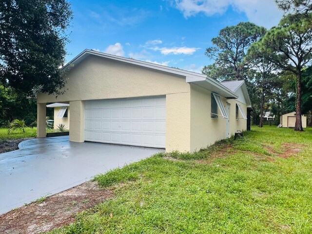 view of home's exterior with a garage and a lawn