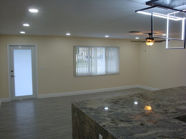 interior space with ceiling fan and hardwood / wood-style flooring