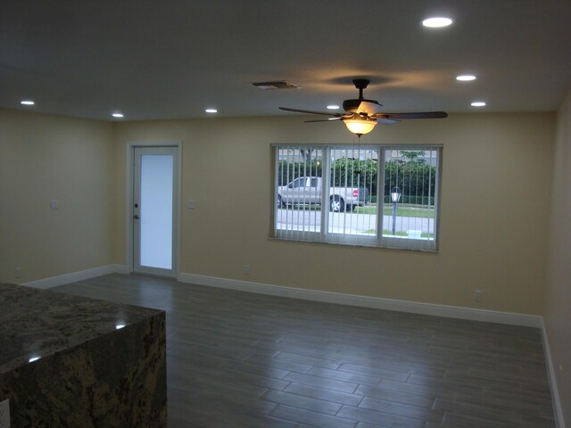 empty room with ceiling fan and wood-type flooring