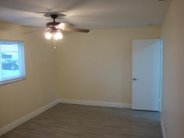 unfurnished room with ceiling fan and wood-type flooring