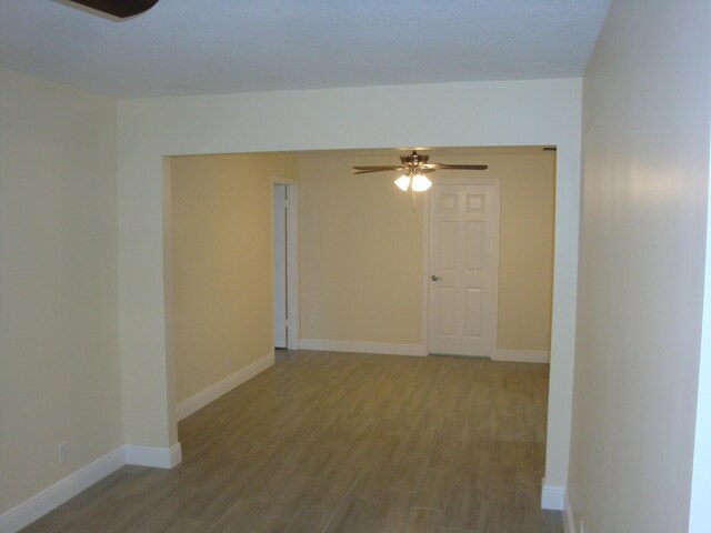 spare room featuring ceiling fan and hardwood / wood-style floors