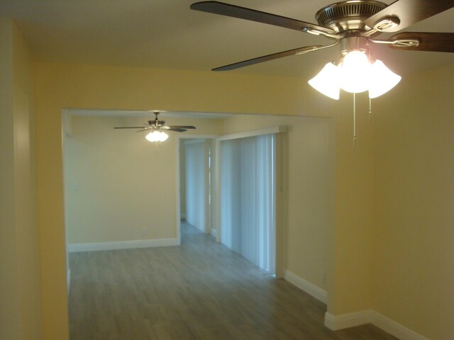 unfurnished room with ceiling fan and hardwood / wood-style floors