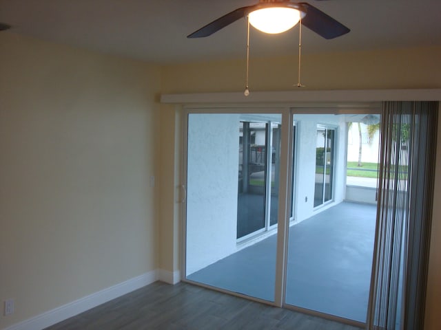 spare room with ceiling fan and wood-type flooring