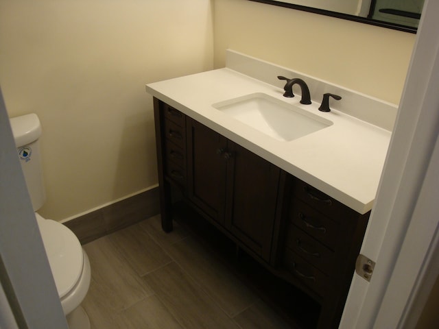 bathroom featuring toilet and vanity